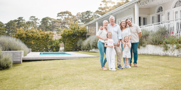 Happy cheerful family standing together outside in the garden. Family relaxing outdoors with their .